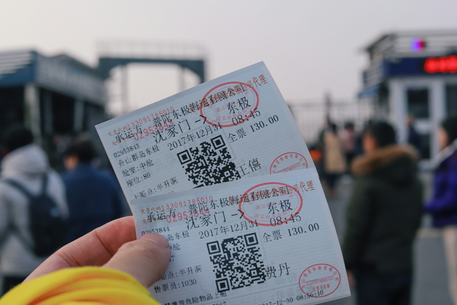 person holding two white tickets